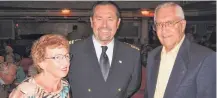  ??  ?? Bob and Dianne Herschelma­n pose with Capt. Brent Willits (center), master of the American Queen, during the farewell reception.