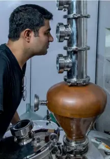  ??  ?? Aditya Aggarwal spent the lockdown mixing botanicals and distilling gin in a mini still in his Delhi home. Above: Rose petal is one of the ingredient­s of Aggarwal’s Samsara gin.