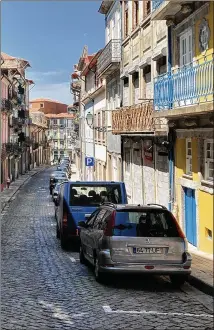  ?? ERIKA MAILMAN FOR THE WASHINGTON POST ?? It can be difficult to pilot a large car along narrow streets, such as this one in Porto, Portugal. Many walled roadways have mere inches on each side.