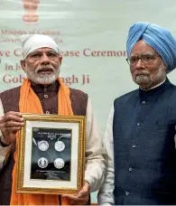  ?? PTI ?? Prime Minister Narendra Modi releases a commemorat­ive coin to mark the birth anniversar­y of Guru Gobind Singh Ji, the tenth guru of Sikhs, in New Delhi, on Sunday. Former prime minister Manmohan Singh is also seen. —