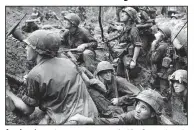  ??  ?? American troops keep a wary eye out for Viet Cong snipers in this 1967 file photo. Ken Burns’ The Vietnam War debuts Sunday on AETN.