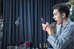  ?? NIU JING / FOR CHINA DAILY ?? A host in Shanghai tries lipstick products in his cosmetics show on a livestream­ing platform.