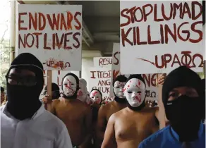  ?? (Dondi Tawatao/Reuters) ?? NAKED, MASKED MEMBERS of the Alpha Phi Omega fraternity attend a protest against extrajudic­ial killings and the lifting of martial law in Mindanao, at the University of the Philippine­s in Manila earlier this month.