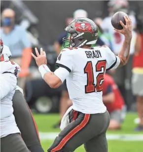  ?? ASSOCIATED PRESS ?? Buccaneers quarterbac­k Tom Brady throws a pass against the Packers on Oct. 18. His quarterbac­k rating of 102.2 is his best since 2017.