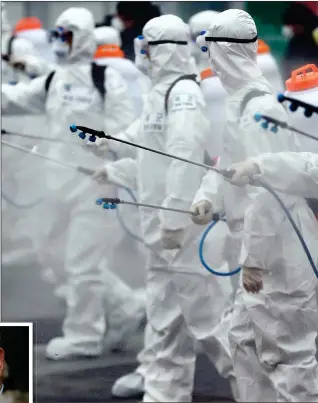  ??  ?? ON ALERT: Soldiers in protective suits spray disinfecta­nt to try to halt the spread of coronaviru­s at a train station in South Korea, where cases are rocketing