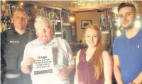  ??  ?? Sgt Jason Middleton and councillor Tim O’Kane testing the wipes at the Albion pub in Clayton-le-Moors with licensees Natalie Graham and Declan Bacigalupo