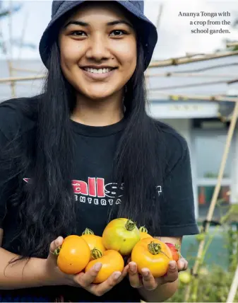  ??  ?? Ananya Tonga with a crop from the school garden.