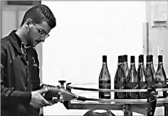  ??  ?? Inspecting the bottles inside Eagle Distilleri­es in Zarqa.