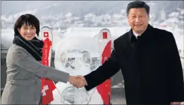  ?? PHOTO: EPA ?? Swiss Federal President Doris Leuthard shakes hands with China’s President Xi Jinping as they launch the Sino-Swiss year of tourism next to a panda ice sculpture on the sidelines of the 47th annual meeting of the World Economic Forum in Davos,...