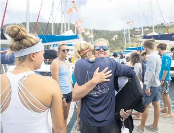  ?? PHOTOS BY ALIE SKOWRONSKI askowronsk­i@miamiheral­d.com ?? Above, dive instructor Jessica Stich, from Pembroke Pines, hugs Dive Director Sydnei Rubin, alumna of the University of Miami, at the end of a session before Stich leaves the British Virgin Islands. Below, The Chimneys, a swim-through rock formation dive at the Dogs Islands.