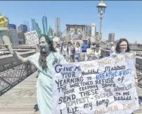  ?? PHOTO: TNS ?? Protesters take part in the End Family Separation NYC Rally and March yesterday on the Brooklyn Bridge, New York City.