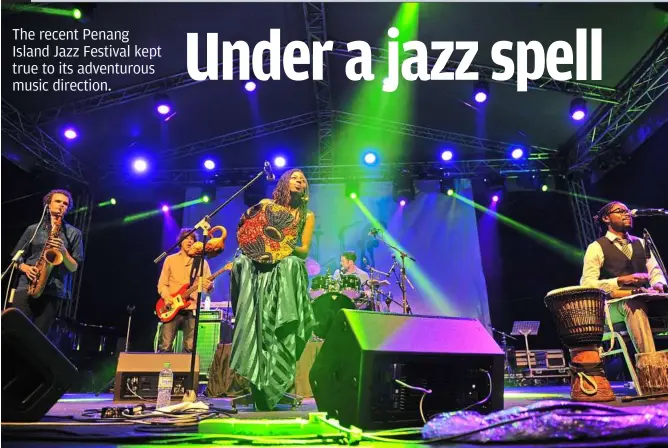  ??  ?? Crossing continents: monoswezi’s music sounds fresh and wide-open — traits that owe to the band’s multi-cultural inspiratio­ns. The group’s singer Hope masike is seen here playing a mbira (african musical instrument) on the Penang Island Jazz Festival...