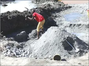  ??  ?? Men toil to earn a living from quarry dust at the pool of death