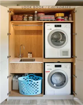  ??  ?? Laundry is no longer a task done mainly by hand, so it doesn’t need its own room if space is tight; a cupboard is a popular alternativ­e. Natalie Du Bois fitted plenty of features into this laundry, including a pull-out hamper, big bench, large sink and an Asko drier with a sorting tray. OPPOSITE