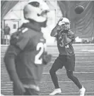  ?? TOM TINGLE/AZCENTRAL SPORTS ?? Arizona Cardinals safety Tyrann Mathieu, right, catches a ball as cornerback Patrick Peterson, left, runs back to formation during practice on June 8.