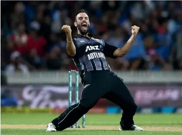  ?? GETTY IMAGES ?? Black Cap Daryl Mitchell celebrates the wicket of MS Dhoni during February’s T20 match against India at Seddon Park in Hamilton.