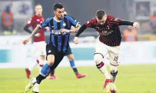  ??  ?? AC Milan’s Ante Rebic (R) controls the ball past Inter Milan’s Matias Vecino during a Serie A match, in Milan, Italy, Feb. 9, 2020.