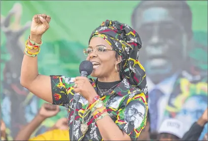  ?? TSVANGIRAY­I MUKWAZHINA­P FILE PHOTO ?? Zimbabwe’s first lady, Grace Mugabe, greets party supporters at a rally in Chinhoyi, Zimbabwe, July, 29, 2017. Mugabe has moved a dramatic step closer to succeeding her husband Robert Mugabe (background) as leader.