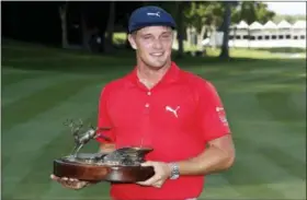  ?? CHARLIE NEIBERGALL — ASSOCIATED PRESS FILE ?? Bryson DeChambeau is photograph­ed with the trophy after winning the John Deere Classic golf tournament at TPC Deere Run in Silvis, Ill., last July.