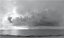  ?? KATHY LASKOWSKI/SOUTH FLORIDA SUN SENTINEL ?? A storm rolls in just after sunrise Wednesday off Fort Lauderdale. Just as a tropical system starts to wash over South Florida, high tides associated with the new moon will bring a potential for flooding.