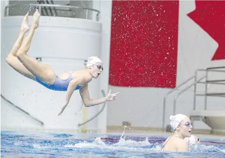  ?? ADRIAN LAM, TIMES COLONIST ?? Audrey Joly of St-Eustache, Que., performs a sequence in the air Tuesday as Canada’s artistic swim team takes part in a pre-Olympic training camp at Saanich Commonweal­th Place. The team will depart for Tokyo on Sunday.