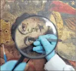  ?? MARTIN MEJIA/THE ASSOCIATED PRESS ?? An art restorer works on a 17th-century painting in a studio at the Ministry of Culture’s Restoratio­n Center in Cuzco, March 1, 2018. The centre receives calls for help from small churches in remote Andean villages that have existed for centuries.