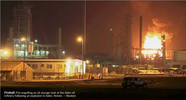  ?? — Reuters ?? Fireball: Fire engulfing an oil storage tank at the Aden oil refinery following an explosion in Aden, Yemen.