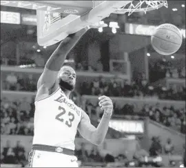  ?? Marcio Jose Sanchez Associated Press ?? THE LAKERS’ LeBron James gets a first-half dunk against Atlanta on Sunday night. He finished with 26 points as the Lakers improved to 7-6.