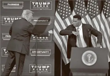  ?? AP-John Bazemore ?? President Donald Trump elbow bumbs with Herschel Walker during a campaign rally, Friday in Atlanta.
