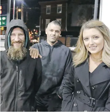  ?? ELIZABETH ROBERTSON / THE PHILADELPH­IA INQUIRER VIA AP ?? Kate McClure, right, and boyfriend Mark D’Amico have raised money for Johnny Bobbitt Jr., left, after he helped her.