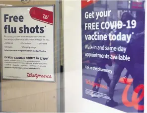  ?? MICHAEL M. SANTIAGO TNS ?? Flu and coronaviru­s (COVID-19) vaccine signage is seen at a Duane Reade on Jan. 5, 2023, in New York City. COVID-19 has subsided but is not expected to disappear. People continue to die.