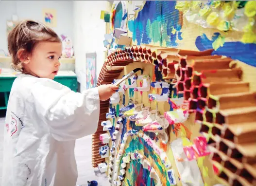  ?? PHOTOS: JOHN MAHONEY ?? Violet Thornhill gets creative with a paint brush at the Jabberwock­y children’s studio, where art activities are included for children signed up for the play area.