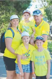  ?? Picture: GLENN HAMPSON ?? Athletics fans Nyree and Zenon O'Donnell with Wyatt 4, Anneka 8, and Talon, 7, from Mackay.