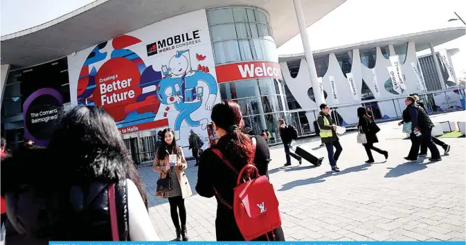  ??  ?? BARCELONA: Workers arrive at the main hall of the Mobile World Congress (MWC) yesterday ahead of the start of the world’s biggest mobile fair, held from February 26 to March 1, 2018 in Barcelona. —AFP