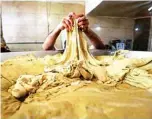  ??  ?? Iranian baker Abbas Abdi, 24 (not seen), prepares Lavash bread dough in Tehran.