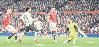  ?? — AFP photo ?? Liverpool’s midfielder Salah (second left) shoots to score their fifth goal, his third during the English Premier League match against Manchester United at Old Trafford in Manchester, north west England.