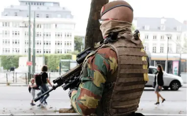  ?? PICTURE: REUTERS ?? GROWING SOFT? A Belgian soldier stands watch during a patrol outside the Palace of Justice in Brussels, Belgium.