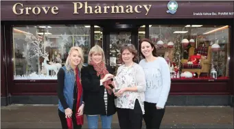  ??  ?? Fiona Magennis of the Drogheda Independen­t presents the award to Niamh, Imelda and Aoife of the The Grove Pharmacy.