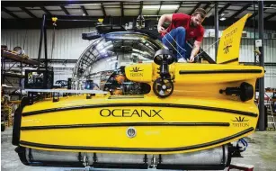  ?? SCOTT MCINTYRE / THE NEW YORK TIMES ?? A tech for OceanX works on a submarine at the Triton Facility in Sebastian, Fla., on Oct. 25, 2019. More lost shipwrecks are being found because of new technology, climate change and more vessels scanning the ocean floor.