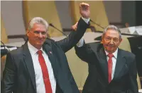  ?? ALEXANDRE MENEGHINI/POOL VIA AP ?? Cuba’s new President Miguel Diaz-Canel, left, raises arms Thursday with outgoing President Raul Castro at the National Assembly in Havana, Cuba.