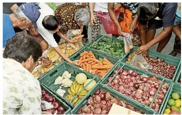  ??  ?? Filepic of Penang residents collecting food from a food bank.