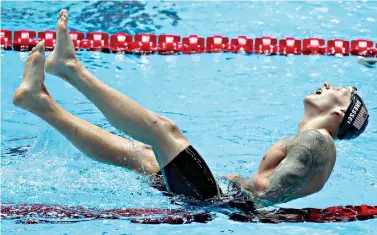  ?? AP Photo/Lee Jin-man ?? ■ United States’ Caeleb Dressel celebrates after winning the men’s 100-meter freestyle final Thursday at the world swimming championsh­ips Thursday in Gwangju, South Korea.