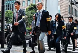  ?? AKIKO MATSUSHITA/KYODO NEWS ?? Japanese regulators head this month to Dentsu’s headquarte­rs for inspection­s. In August 2015, authoritie­s caught Dentsu exceeding its own 70-hour monthly overtime limit.