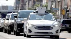  ?? Darrell Sapp/Post-Gazette ?? An Argo self-driving test vehicle sits at a light on June 30 Liberty Avenue in the Bloomfield business district. on