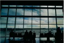  ?? AP PHOTO BY BRYNN ANDERSON ?? Travelers watch as a plane takes off from Hartsfield-jackson Atlanta Internatio­nal Airport in Atlanta, Tuesday, Nov. 22, 2022. On Friday, Jan. 27, 2023, The Associated Press reported on stories circulatin­g online incorrectl­y claiming the FAA loosened the requiremen­ts that airline pilots must meet for cardiac health because of COVID-19 vaccine side effects.