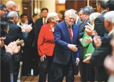  ?? BOB ANDRES/ATLANTA JOURNAL-CONSTITUTI­ON VIA AP ?? Georgia Gov. Nathan Deal and first lady Sandra Deal are greeted with a standing ovation as they enter the House where Deal addressed them for his last Sine Die. Thursday was the 40th and final day of the 2018 General Assembly.