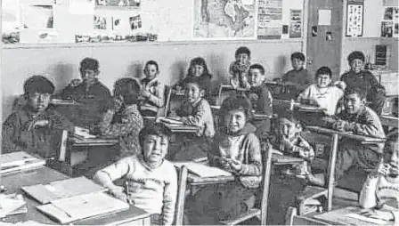  ?? CONTRIBUTE­D ?? Miriam Saunders (front left) is pictured in a classroom at Melville residentia­l school.