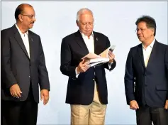  ??  ?? Prime Minister Datuk Seri Najib Tun Razak (centre) taking a closer look at the NTP Annual Report 2017 at its launching. Also present are chief secretary to the government Tan Sri Dr Ali Hamsa (left) and adviser to the PM on NTP Datuk Seri Idris Jala. — Bernama photo