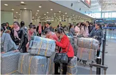  ?? — AFP ?? North Korean workers queuing for a flight to Pyongyang at an airport in Beijing.