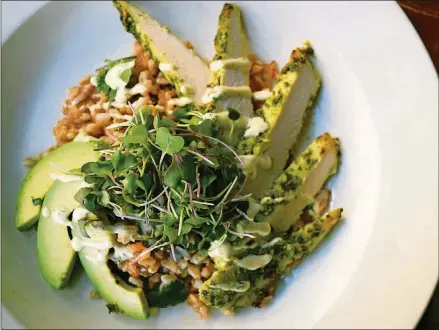  ?? CONTRIBUTE­D BY TORI ALLEN PR ?? Ryan Burke’s Green Grain Bowl includes farro, pesto-coated chicken, avocado slices, Green Garlic Aioli and a garnish of kale microgreen­s.